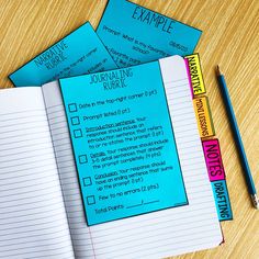 three notebooks sitting on top of a wooden table next to a pencil and eraser