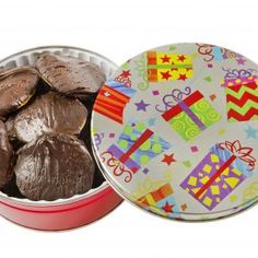 a tin filled with chocolate covered pastries next to a container full of wrapped presents