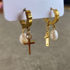 "Dainty Jesus and 8 mm Pearl Earrings This design earrings are made of freshwater pearl and 18K gold filled cross. Pearl is used in our earrings, especially because of the luster. This luster fits perfectly with both your daily outfits and special occasions.   Forget the old saying, \"Pearls bring tears.\" Given pearl symbolism of wisdom, enlightenment, innocence, serenity, protection, and longevity, it's safe to say that pearls are associated with good luck. ☆ If you are a pearl lover, you will Gold Huggie Pearl Earrings With Ear Wire, Gold Huggie Earrings With Pearl Charm For Gift, Gold Huggie Earrings With Pearl Charm As Gift, Gold Huggie Pearl Earrings For Gift, Gold Huggie Pearl Earrings As Gift, Pearl Cross Earrings, Pearl Symbolism, Preppy Jewelry, Jewelry Accessories Ideas