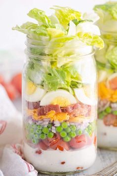 salad in a jar with eggs and lettuce on the side, ready to be eaten