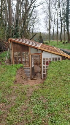 a small chicken coop in the middle of a field