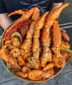 a bowl full of cooked shrimp and other seafood