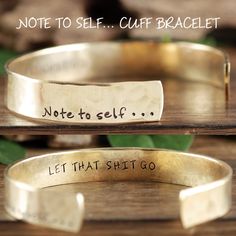 two gold bracelets with handwriting on them and one saying note to self cuff bracelet