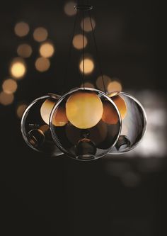 a chandelier hanging from a ceiling with lights in the background and circles around it