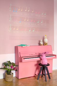 a pink piano sitting on top of a wooden floor