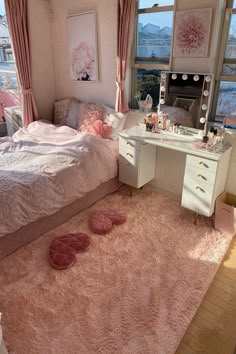 a bedroom with a pink rug and white bed in the corner next to a large window