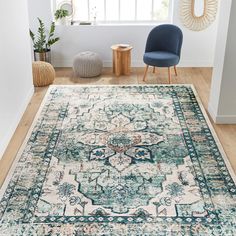 a blue and white rug in a living room next to a chair with a plant on it