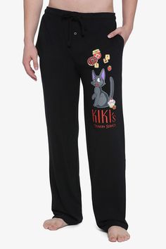 a man wearing black pajamas with cartoon characters on it