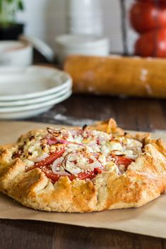 a pizza sitting on top of a wooden table