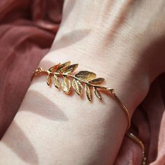 Leaf Bracelet // Woodland Wedding // Rustic Wedding // Bridesmaids Gift // Boho Bridal Jewelry // Summer Jewelry // Box Chain Bracelet // Adjustable Bracelet   This beautiful nature inspired bracelet features a large detailed leaf in gold and is secured to a dainty box chain bracelet. The leaf bracelet can be adjusted by gently moving the slider bead for a comfortable fit. Embellished to each end are tiny cubic zirconia for a dash of sparkle. Whether searching for a woodland wedding themed bracelet as a bridesmaids gift or something special to wear on your wedding day, all of my jewelry arrives suitably gift wrapped ready for gift giving. Size: The size of the leaf bracelet is adjustable and is light weight, the leaves can be gently pressed to shape and form them close to the wrist if need Gold Wedding Jewelry Gift, Handmade Gold Bracelets For Wedding, Elegant Gold Bracelets As Wedding Gift, Elegant Gold Bracelets For Wedding Gift, Silver Bracelets For Wedding Gifts, Delicate Gold Bracelets For Wedding, Elegant Handmade Bracelet As Wedding Gift, Elegant Handmade Bracelet For Wedding Gift, Gold Bangle Chain Bracelet For Wedding