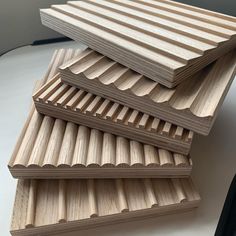 three pieces of wood stacked on top of each other in the shape of slats