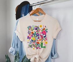 "Wildflower Tshirt, Wild Flowers Shirt, Floral Tshirt, Flower Shirt, Gift for Women, Ladies Shirts, Best Friend Gift Shirt,Nature Lover Shirt ⭐Please Check All Photos For Details. 🐞Choose Your T-Shirt Size From The Drop-Down Lists Next To The item Picture ⭐Choose Of Your T-Shirt Color From The 2nd Picture 🐞Use \"Add message to Seller\" link On The Checkout Page To Send me the Following important Details For Your Order's Customization. ⭐Shipping Time Varies by location (we are located in Sugar Floral Tshirt, Ladies Shirts, Nature Shirts, Gardening Shirts, Outdoor Shirt, Flower Shirt, Best Friend Gift, Spring Shirts, Art Styles