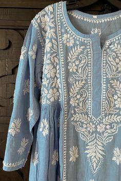 Made of soft skin-friendly pure cotton fabric, this charming light-blue handcrafted Lucknowi Chikankari A-line Women's Kurta long dress is an exceptional piece that will never go out of style. Featuring intricate Lucknowi Chikankari embroidery, it's perfect for everyday wear. Pure cotton Length 44" inches Long sleeves 19" inches Round neck A line Lucknowi chikankari embroidery handwork Soft wash Fit: True to sizeInside Margin: NoTouch and Feel: Soft and ComfortableDispatched in 1-3 business days Chickenkari Neck Design, Chikankari Neck Designs, Chicken Curry Kurta, Lucknowi Kurta Woman, Luxury Bollywood Tops With Chikankari Embroidery, Cotton Chickenkari Suits, Chikankari Kurta Women, Everyday Kurti, Chikankari Kurta Designs