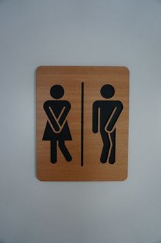 a wooden sign with the image of a man and woman