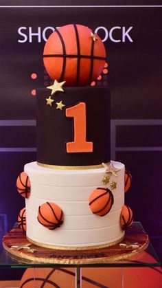 a basketball themed birthday cake with stars on the top and number one on the bottom