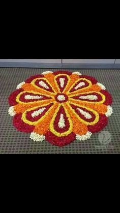 an orange and yellow flower on the ground