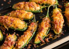 stuffed peppers with cheese and other toppings on a baking sheet