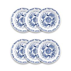 four blue and white plates with floral designs on the rims, set against a white background