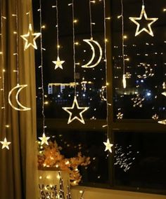 the window is decorated with stars and moon lights