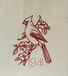 a red bird sitting on top of a white sheet with flowers and leaves around it