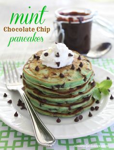 stack of mint chocolate chip pancakes on a plate with whipped cream and chocolate chips next to it