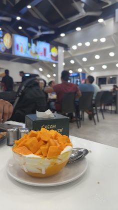 a white plate topped with food on top of a table next to a box of chips