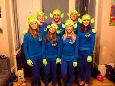 a group of people dressed in blue and green costumes posing for a photo with each other