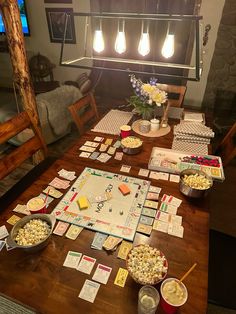 a wooden table topped with lots of different types of snacks and drinks on top of it