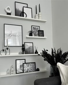 some white shelves with black and white pictures on them