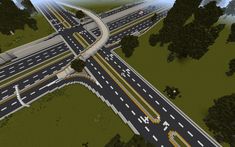 an aerial view of a highway intersection with multiple lanes and traffic lights in the distance