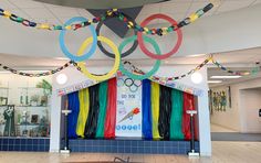 the olympic rings are hanging from the ceiling