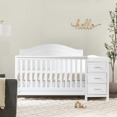 a baby crib in a room with white furniture