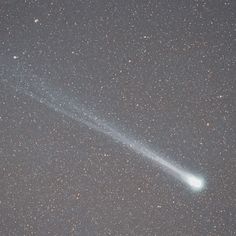 an image of a comet in the sky with stars on it's side and one light emitting from its tail