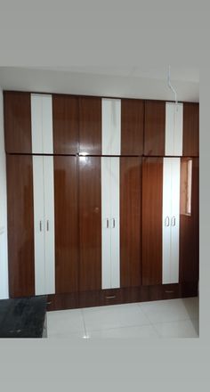 an empty room with white and brown cabinets