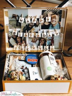 an open birthday box with pictures and letters