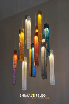 a multi colored glass chandelier hanging from the ceiling