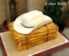 a cake made to look like a cowboy's hat on top of some straw