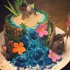 a cake decorated with blue icing and flowers