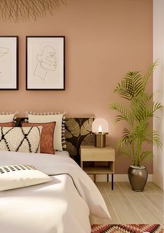 a bedroom with pink walls and white bedding