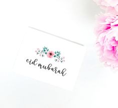 a pink flower next to a white card with the word'el munara'written on it