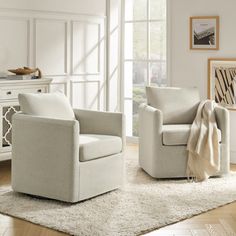 a living room with two chairs and a rug