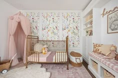 a baby's room with floral wallpaper and pink bedding in the corner