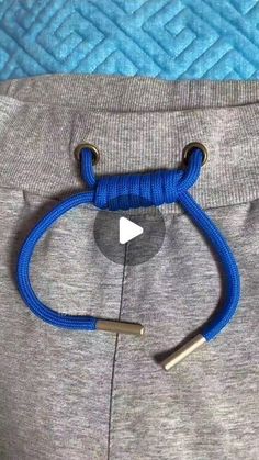 a close up of a person's pants with a blue rope on the bottom