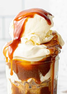 an ice cream sundae with caramel drizzle and whipped cream on top