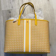 Tory Burch Yellow Coated Canvas Tote Bag. Brand New! No Flaws, No Signs Of Use Or Wear. Yellow And White Coated Canvas Bag With Leather Trim. Tags Are Still Attached. Tory Burch Robinson Tote, Tory Burch Ella Tote, Orange Tote Bags, Ella Tote, Yellow Tote Bag, Burgundy Bag, Tory Burch Bag Totes, Tory Burch Tote, Canvas Beach Bag