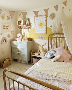 a child's bedroom decorated in pink, yellow and white with lots of decorations