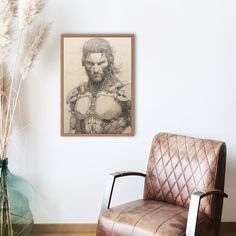 a chair sitting next to a vase with flowers in it and a drawing on the wall