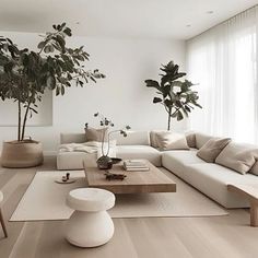 a living room filled with lots of white furniture