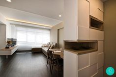 the interior of a modern apartment with wood flooring and white walls, along with an open kitchen area