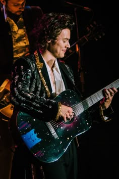 a man playing an electric guitar on stage